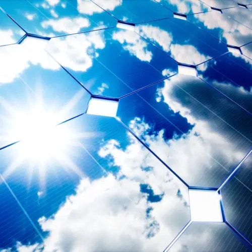 Sun reflected in a photovoltaic solar panel