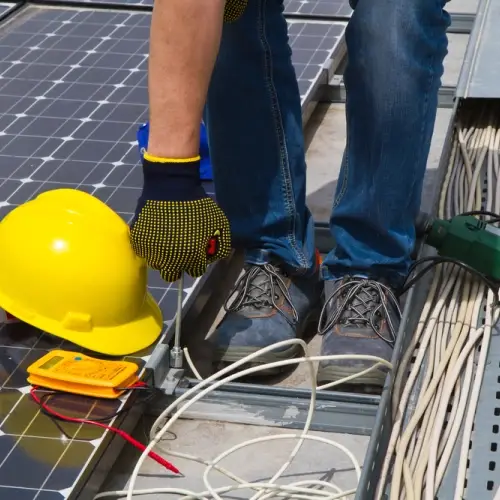 Installer performing maintenance on photovoltaic panels